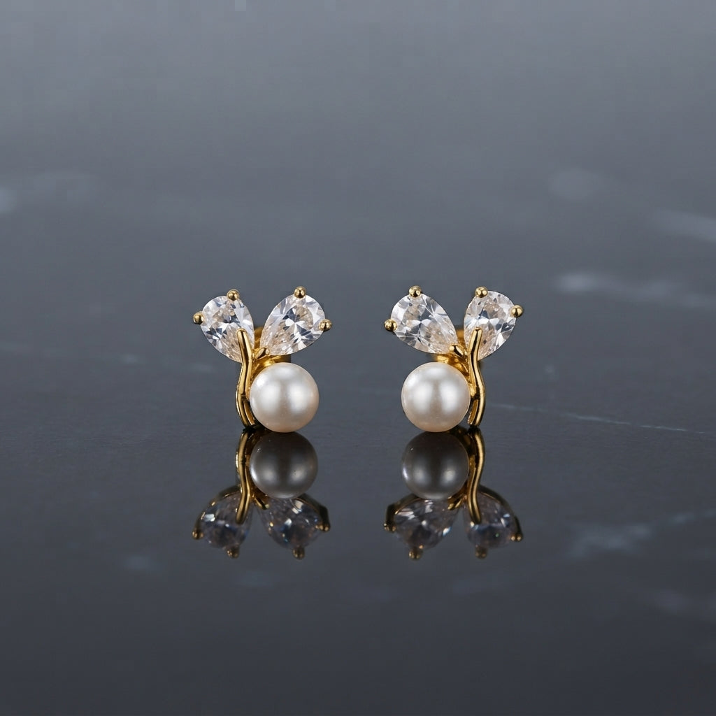 Pair of gold-tone earrings with white pearl-look round beads and clear faceted petal-shaped accents.