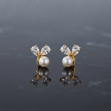 Pair of gold-tone earrings with white pearl-look round beads and clear faceted petal-shaped accents.