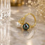Gold-Tone White & Black Pearl CZ Lotus Crown Toi et Moi Bypass Ring product shot on marble surface