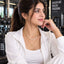 Gold Triple-Layer Pearl Station & Open Heart Pendant Layered Necklace worn by model in white gym outfit at gym setting