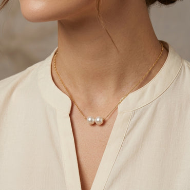 Gold Twin Double Pearl Minimalist Floating Chain Necklace — 18K gold-tone delicate cable chain necklace with 2 round freshwater white pearls threaded side-by-side at center floating twin pearl minimalist design at collarbone length