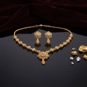 Gold Two-Tone Filigree Fan Pendant Necklace and Melon Drop Earrings Set with CZ Station Chain — 22K antique gold-tone 2-piece set with square CZ micro-pavé station chain large 3-tier fan scallop filigree pendant with rhodium spoke center and gold melon mesh drop and matching round dome filigree flower melon drop earrings displayed on dark mirror surface with burgundy crimson velvet backdrop gold nuggets and loose CZ props