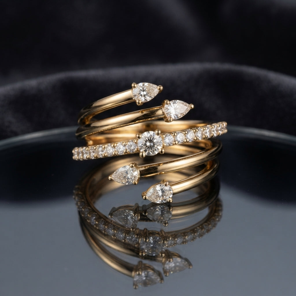 Gold White CZ Pear Multi-Spiral Wrap Coil Cocktail Ring — five-coil 22K gold serpenti wrap band with large pear CZ claw accents at top and base and full round white CZ micro-pavé middle coil, luxury product flat-lay on round mirror tray with dark charcoal silk backdrop