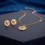 Gold White Enamel Medusa Head Pendant Necklace Earrings Set — 2-piece set of fine 22K gold cable chain with large white enamel Medusa disc pendant and matching white enamel Medusa stud earrings with Greek key border, editorial display on dark navy hexagonal lacquer stand with deep blue velvet backdrop