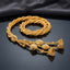 Gold Zari Baby Paranda traditional South Asian braided hair accessory coiled on dark mirror surface with charcoal slate satin backdrop showing warm antique 22K gold-tone multi-strand herringbone twisted zari cord body with ornate 3-strand filigree tassel cluster featuring diamond-cut bicone beads open filigree cone caps and gold ball bead detailing with mirror reflection below