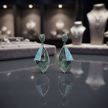 Collage showing a model wearing gold-tone green and turquoise geometric drop earrings, with pair and close-up views.