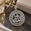 Silver-tone round Allah calligraphy pendant with clear accents, two circular borders, geometric openwork, and an embellished hanging loop.