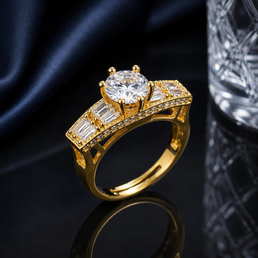 Golden CZ solitaire statement ring with round center stone and baguette side detailing