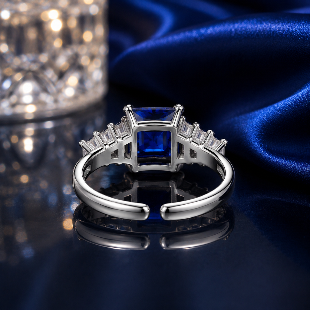 Back view of navy blue CZ princess cut baguette accent adjustable open-band ring in silver-tone finish showing the open adjustable band