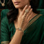 Kundan Pearl Hath Phool Bracelet Ring Gold product shot worn on model hand over green velvet with jewellery box backdrop showing gold-tone kundan polki flower wrist station pear CZ links with faux pearl drops and matching finger ring cluster