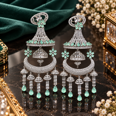 Pair of silver-tone mint-green chandelier earrings with clear faceted details, floral accents, and multiple dangling elements.
