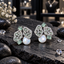 Pair of gold-tone cluster earrings with mint green accents, sparkling openwork panels, rectangular details and white pearl-look centres.