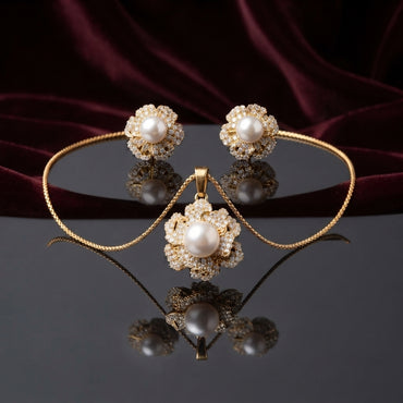 Pearl Center CZ Multi-Layer Floral Halo Pendant Necklace and Earrings Set in silver-tone flat lay on grey mirror surface with navy blue velvet backdrop showing 2-piece set with large cream pearl center in dense multi-layer white CZ floral sunburst halo pendant necklace and matching stud earrings with mirror reflection