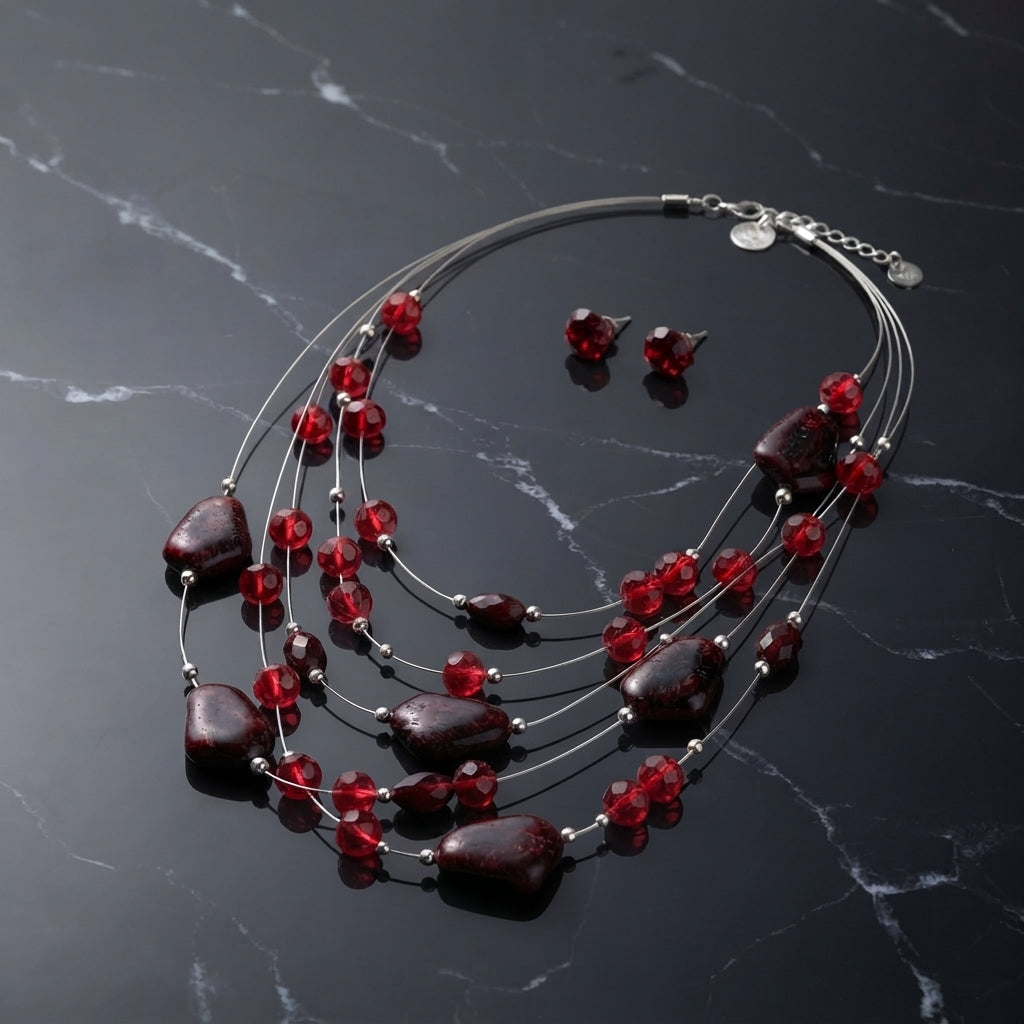 Multi-strand necklace with red faceted beads, larger dark brown beads, and matching red stud earrings.