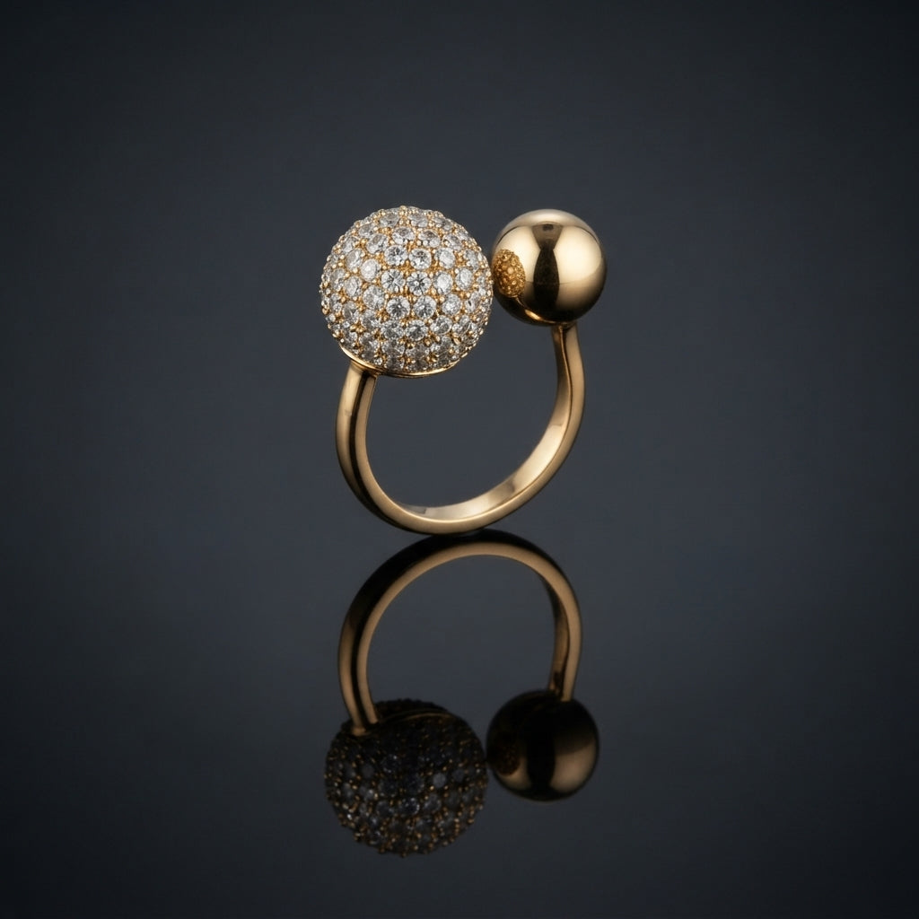 Rose Gold CZ Pavé Ball Open Bypass Adjustable Ring — rose gold-tone open adjustable bypass ring with large fully iced round white CZ micro-pavé sphere and smaller plain polished rose gold ball on slim wire shank, on dark grey mirror surface with luxury editorial backdrop