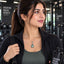 Silver Aqua Teal Oval CZ Solitaire Drop Pendant Necklace worn by model in black gym jacket at gym setting with black gym equipment backdrop