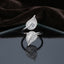 Silver Baguette CZ Leaf Teardrop Open Cocktail Ring on dark grey mirror surface with dark brown velvet drape backdrop