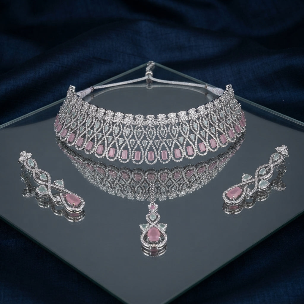 Silver Blush Pink CZ Infinity Crossover Wide Bib Choker & Drop Earrings Bridal Set on black mirror surface with dark navy blue silk drape backdrop