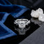 Silver-Tone Cushion-Cut CZ Solitaire Twisted Infinity Pavé Band Engagement Ring on black reflective surface with navy blue velvet fabric and white quartz crystal cluster backdrop