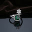 Silver Emerald Green Cushion CZ Halo Floral Crown Open Cocktail Ring on dark grey mirror surface with dark brown velvet drape backdrop