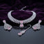 Silver CZ Cluster Choker Earrings and Maang Tikka Bridal Set in Rose Pink on dark mirror surface with purple velvet backdrop showing rhodium silver wide white CZ cluster choker with rose pink CZ square and pear pendant halo matching fan-drop earrings and maang tikka