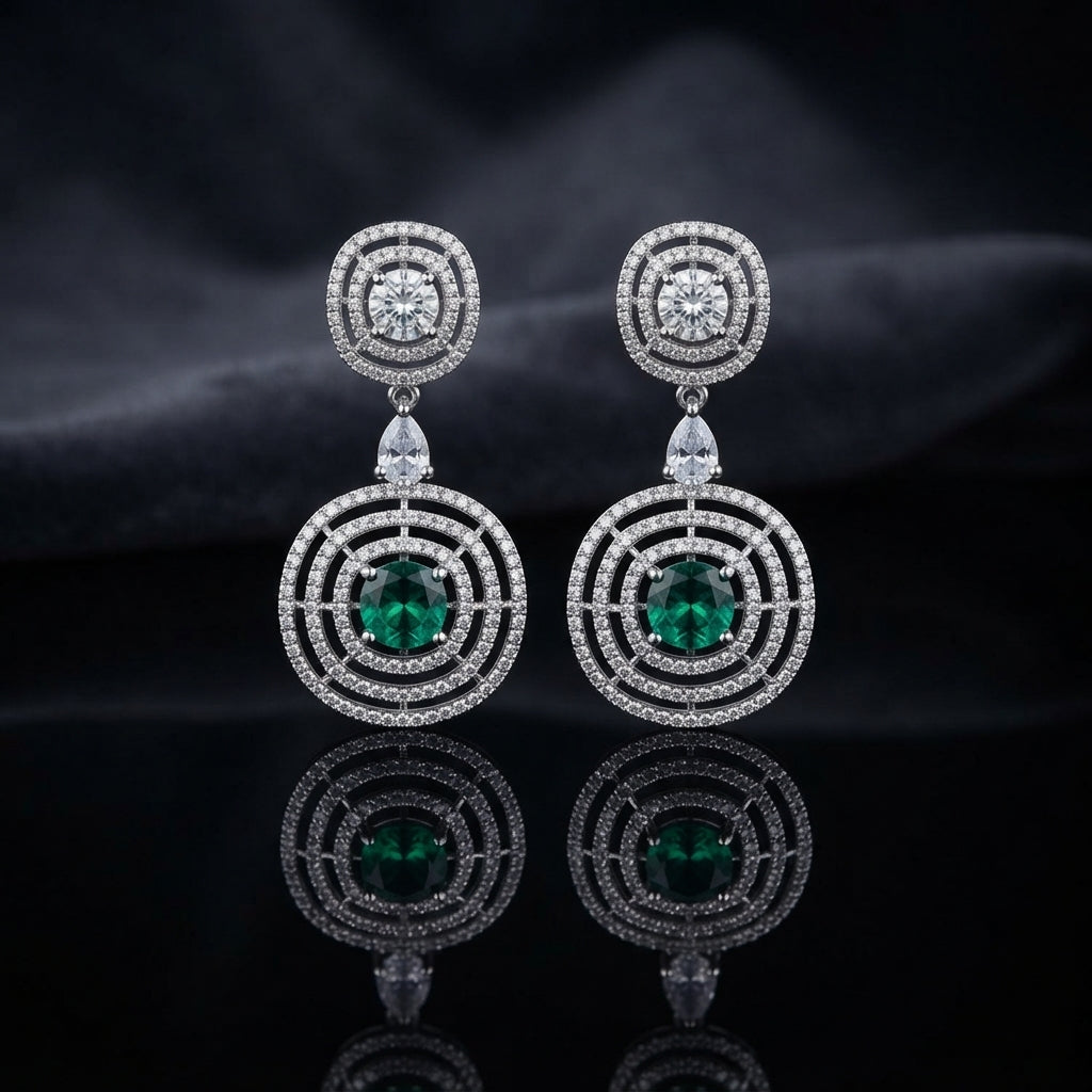 Silver CZ Concentric Orbit Double Disc and Pear Connector Drop Earrings in Smoke Grey on dark mirror surface with charcoal satin backdrop showing rhodium silver pair with concentric cushion orbit stud white pear connector and large orbit disc pendant with round cushion smoky grey CZ centre solitaire