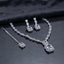 Silver CZ Emerald-Cut Baguette Tennis Necklace Earrings and Maang Tikka Set in Diamond White on dark charcoal satin surface showing rhodium silver full baguette CZ tennis necklace with double white CZ halo pendant matching drop earrings and maang tikka