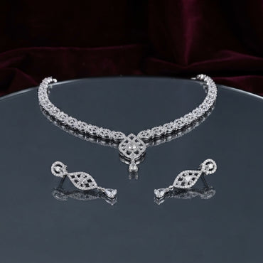 Silver CZ Floral Lattice Choker Necklace and Marquise Teardrop Earrings Bridal Set — rhodium silver-tone 2-piece bridal set with full-coverage continuous CZ micro-pavé floral lattice choker with Gothic arch fleur-de-lis center V-drop and hanging teardrop CZ pendant and matching elongated marquise CZ frame drop earrings displayed on dark mirror round tray with burgundy velvet backdrop