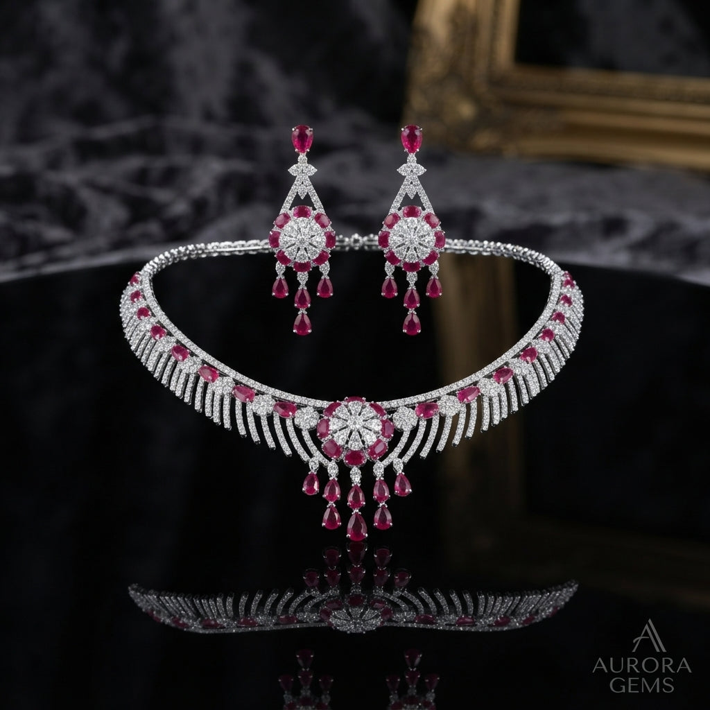 Silver CZ Fringe Choker Starburst Medallion Grand Bridal Parure Set in Ruby Red — rhodium-plated silver-tone 2-piece grand bridal set with wide micro-pavé CZ fringe choker with ruby red oval cabochon stations and starburst medallion center with cascading ruby pear drops, with matching 4-tier ruby red chandelier earrings on dark black mirror luxury editorial backdrop