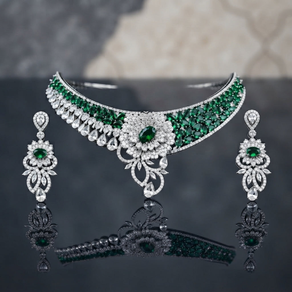 Silver CZ Grand Collar Bridal Necklace and Earrings Set in Sapphire Blue worn by South Asian model in navy blue embroidered gharara with chandelier backdrop showing wide crescent collar choker with deep blue oval CZ stones and grand floral bouquet pendant with matching drop earrings