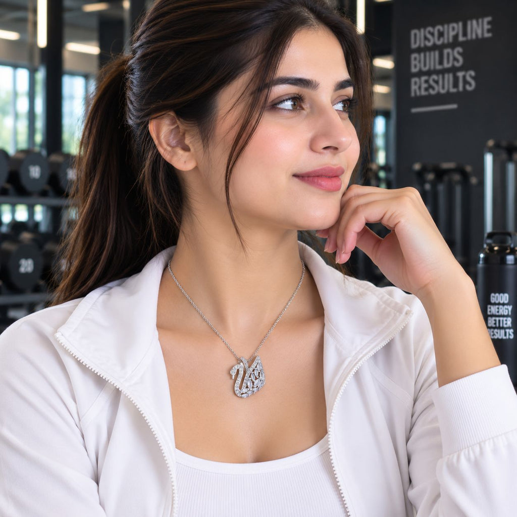 Silver CZ Marquise & Pavé Swan Pendant Bridal Necklace worn by model in white gym jacket at gym setting