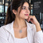 Silver CZ Marquise & Pavé Swan Pendant Bridal Necklace worn by model in white gym jacket at gym setting