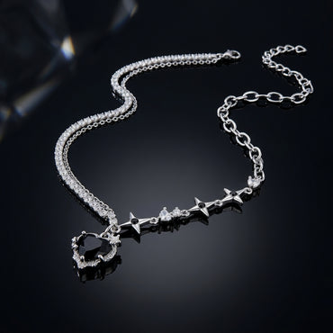 Silver-Tone CZ Tennis Star Heart Asymmetric Layered Necklace with dual chain and open heart pendant on dark surface