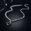 Silver-Tone CZ Tennis Star Heart Asymmetric Layered Necklace with dual chain and open heart pendant on dark surface