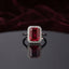 Silver Emerald Cut CZ Rectangular Halo Pave Band Solitaire Ring in Diamond White Clear CZ variant on dark mirror surface with charcoal satin backdrop showing brilliant clear diamond-illusion emerald-cut CZ solitaire in 4-claw setting with full rectangular white CZ halo and continuous micro-pave white CZ band in rhodium silver with mirror reflection below
