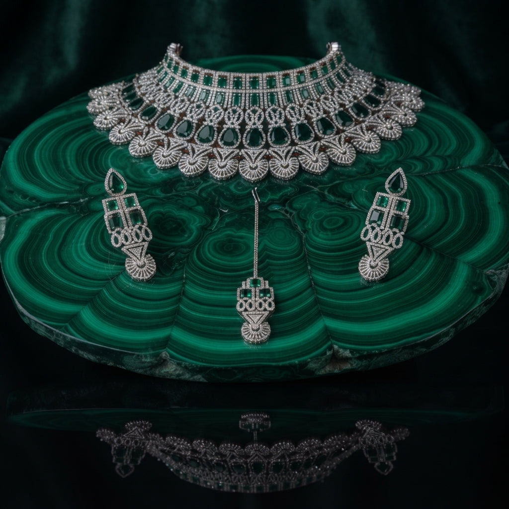 Silver Emerald Green CZ Art Deco Peacock Fan Wide Bib Choker Earrings & Maang Tikka Bridal Set on green malachite stone tray with dark green velvet drape backdrop