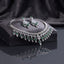 Silver Emerald Green CZ Fringe Tassel Bridal Necklace and Earrings 2-Piece Luxury Set on dark charcoal stone display block with dark grey silk backdrop showing grand V-fringe statement necklace with double-row baguette CZ top bar and graduated emerald green pear CZ tassel drops with matching chandelier drop earrings featuring emerald green CZ cluster and teardrop drops with mirror reflection below