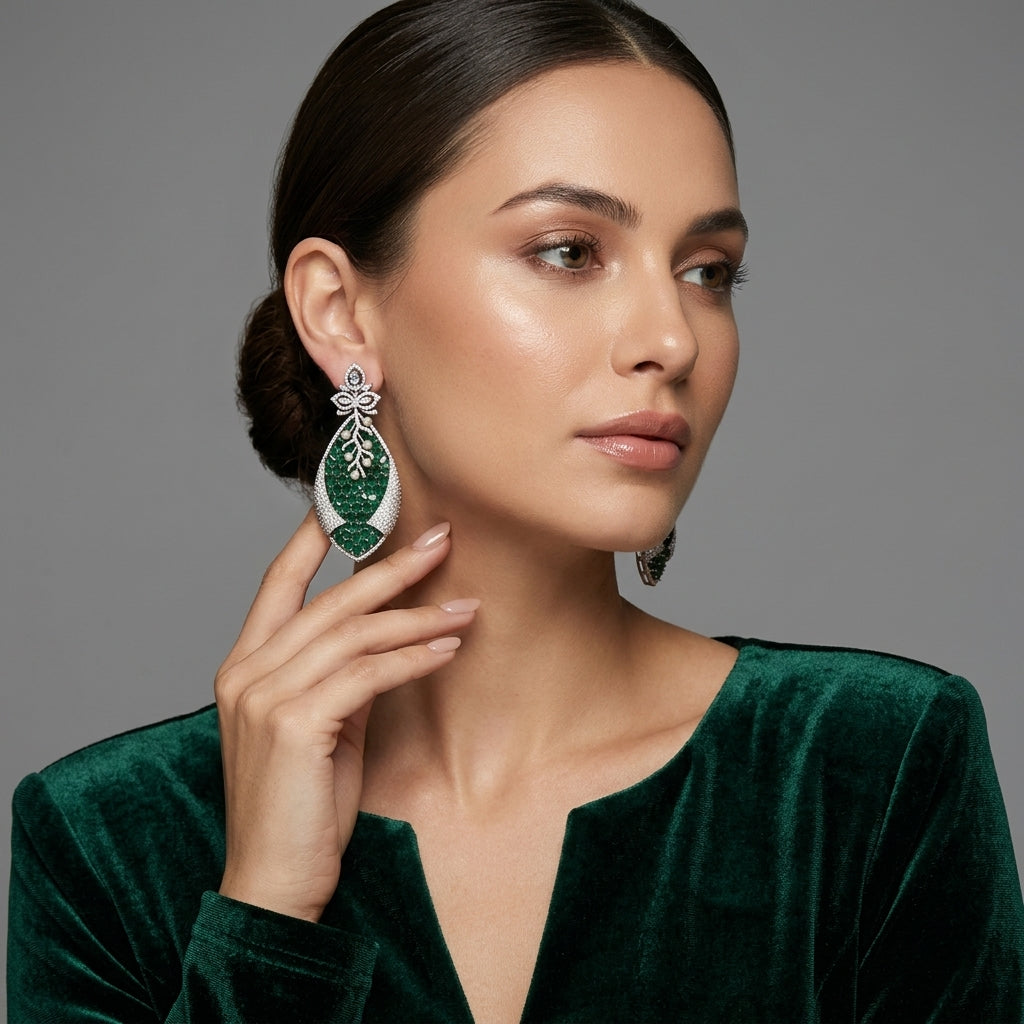 Silver Emerald Green CZ Oval Cluster and Pearl Vine Twisted Leaf Grand Drop Earrings flat lay on ivory cream fabric backdrop showing pair detail of white CZ marquise lotus stud and massive twisted leaf drop with dense oval emerald green CZ cluster face white CZ micro-pavé outer frame and pearl vine overlay