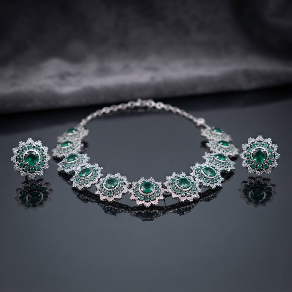 Silver Emerald Green CZ Sunburst Oval Station Collar Necklace and Stud Earrings Set worn by model in emerald green silk kurta in luxury boutique setting showing necklace and stud earrings styling