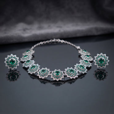 Silver Emerald Green CZ Sunburst Oval Station Collar Necklace and Stud Earrings Set worn by model in emerald green silk kurta in luxury boutique setting showing necklace and stud earrings styling