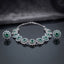 Silver Emerald Green CZ Sunburst Oval Station Collar Necklace and Stud Earrings Set worn by model in emerald green silk kurta in luxury boutique setting showing necklace and stud earrings styling