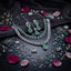 Silver Mint Green CZ and White CZ Marquise Floral Tennis Necklace and Earrings Bridal Jewelry Set editorial flat lay on dark mirror surface with rose petals and silver lotus props showing rhodium silver-tone necklace with mint green cabochon and white marquise CZ tennis band large square and pear mint green CZ pendant with white CZ halo marquise leaf fringe and matching drop earrings
