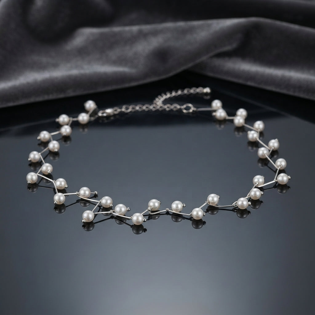 Silver Floating Pearl Vine Branch Choker Necklace on dark grey mirror surface with dark grey velvet drape backdrop