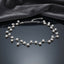 Silver Floating Pearl Vine Branch Choker Necklace on dark grey mirror surface with dark grey velvet drape backdrop