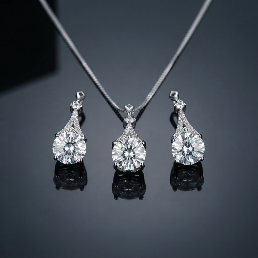 Silver-Tone Large Round Brilliant CZ Solitaire & Pavé Teardrop Cap Pendant Necklace & Drop Earrings Jewelry Set flat lay on dark reflective surface showing pendant and matching drop earrings