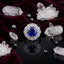 Silver-Tone Large Round Sapphire Blue CZ Sunburst Marquise & Micro-Pavé Double Halo Bridal Cocktail Ring on black mirror surface with white crystal quartz clusters, hematite beads and deep burgundy velvet backdrop