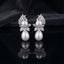 Silver-Tone Marquise CZ Wheat Leaf Cluster Double Pearl Drop Earrings on black mirror surface with dark grey silk fabric backdrop