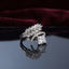 Silver Marquise Leaf Crown Princess CZ Adjustable Cocktail Ring in White Diamond — rhodium-plated open adjustable ring with marquise white CZ leaf crown, micro-pavé arc, and brilliant clear white diamond-illusion princess cut center stone, on dark mirror with burgundy velvet backdrop