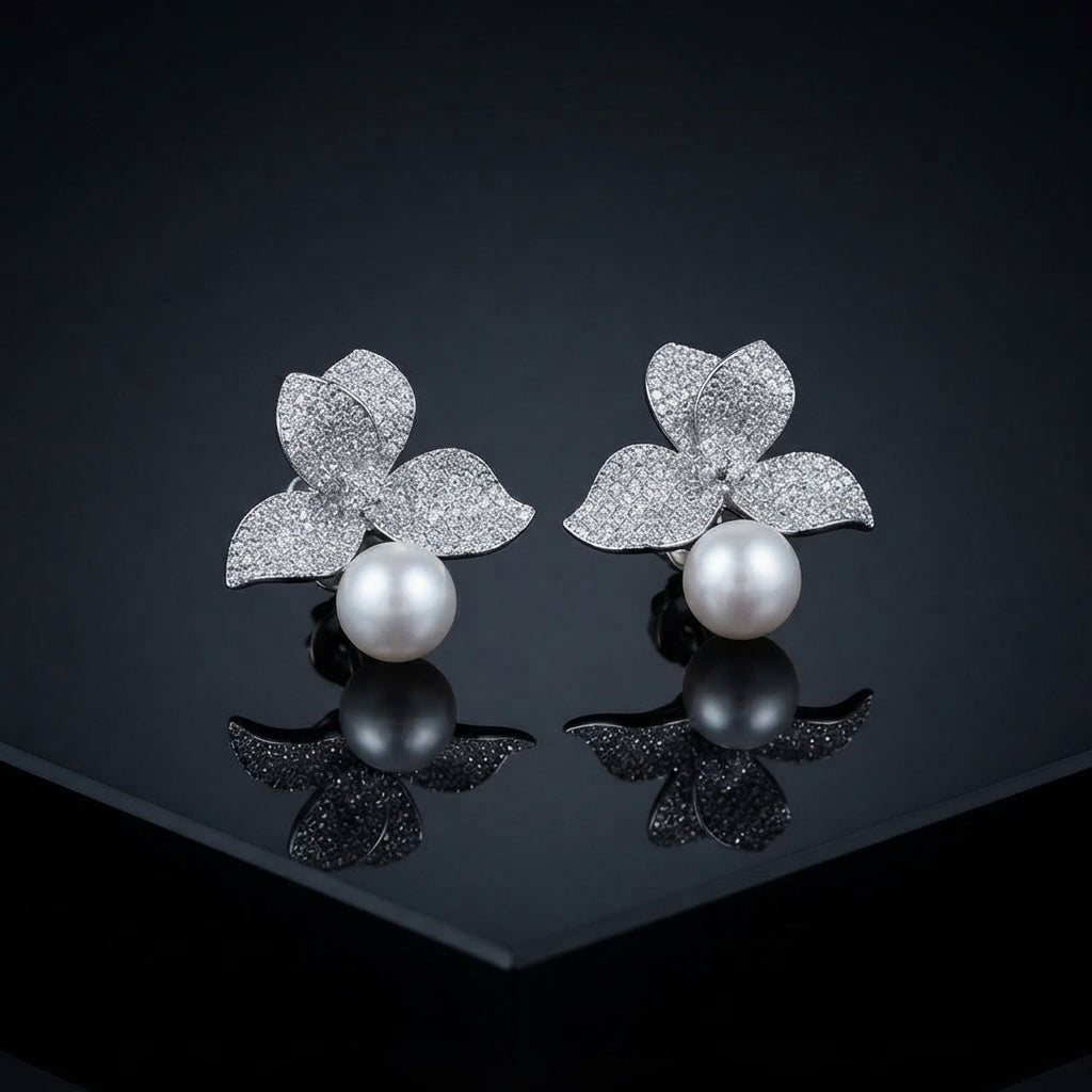Silver-Tone Micro-Pavé CZ Triple Leaf Flower Cap & South Sea Pearl Stud Earrings on black mirror surface with dark background