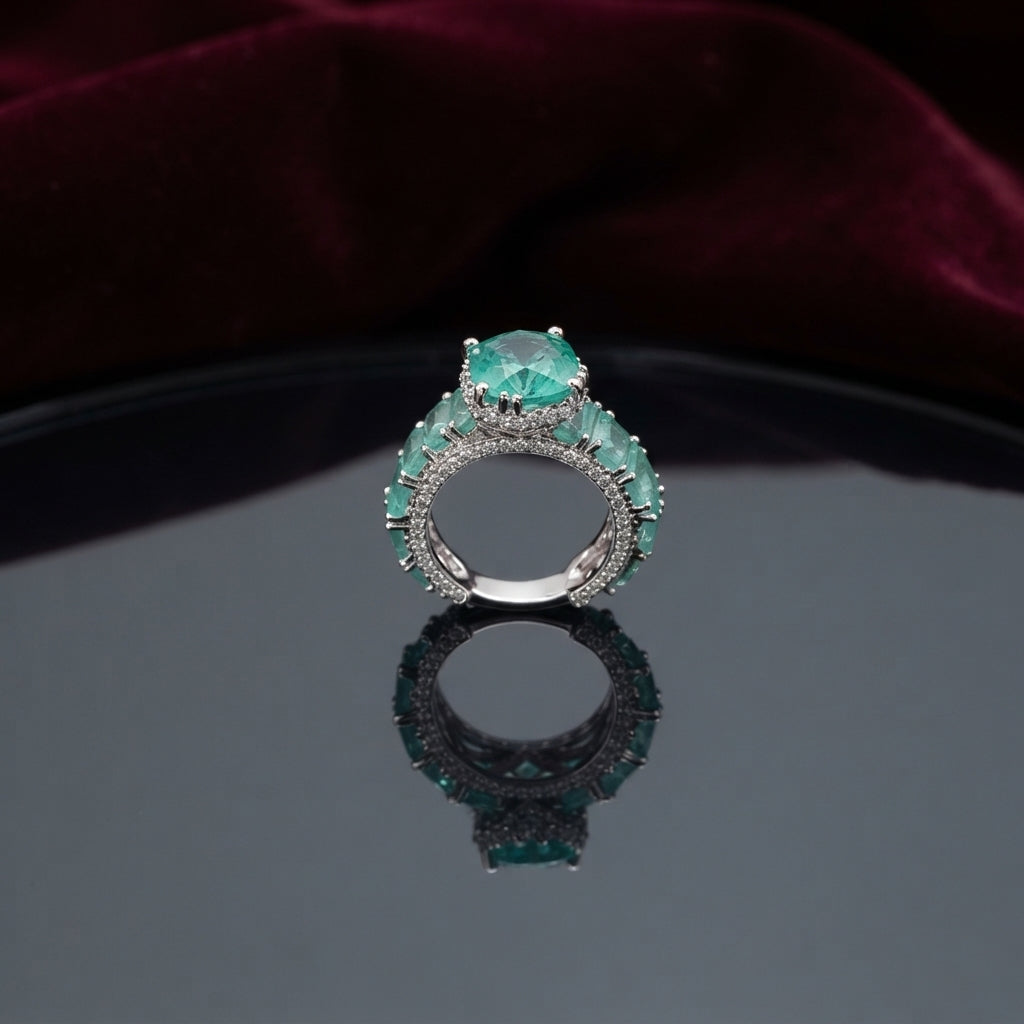 Silver CZ Statement Cocktail Ring in Paraiba Teal — very large round teal CZ center with marquise teal shoulder stones on full white CZ pavé dome band on burgundy velvet backdrop